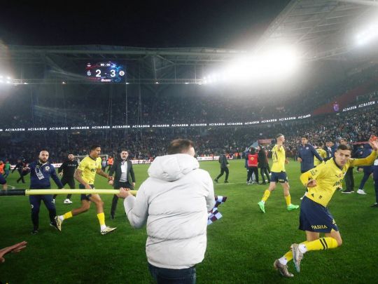 З ножами та кутовими прапорцями в руках: футболісти «Фенербахче» та фанати «Трабзонспора» влаштували жорстоку бійку просто на полі (відео)